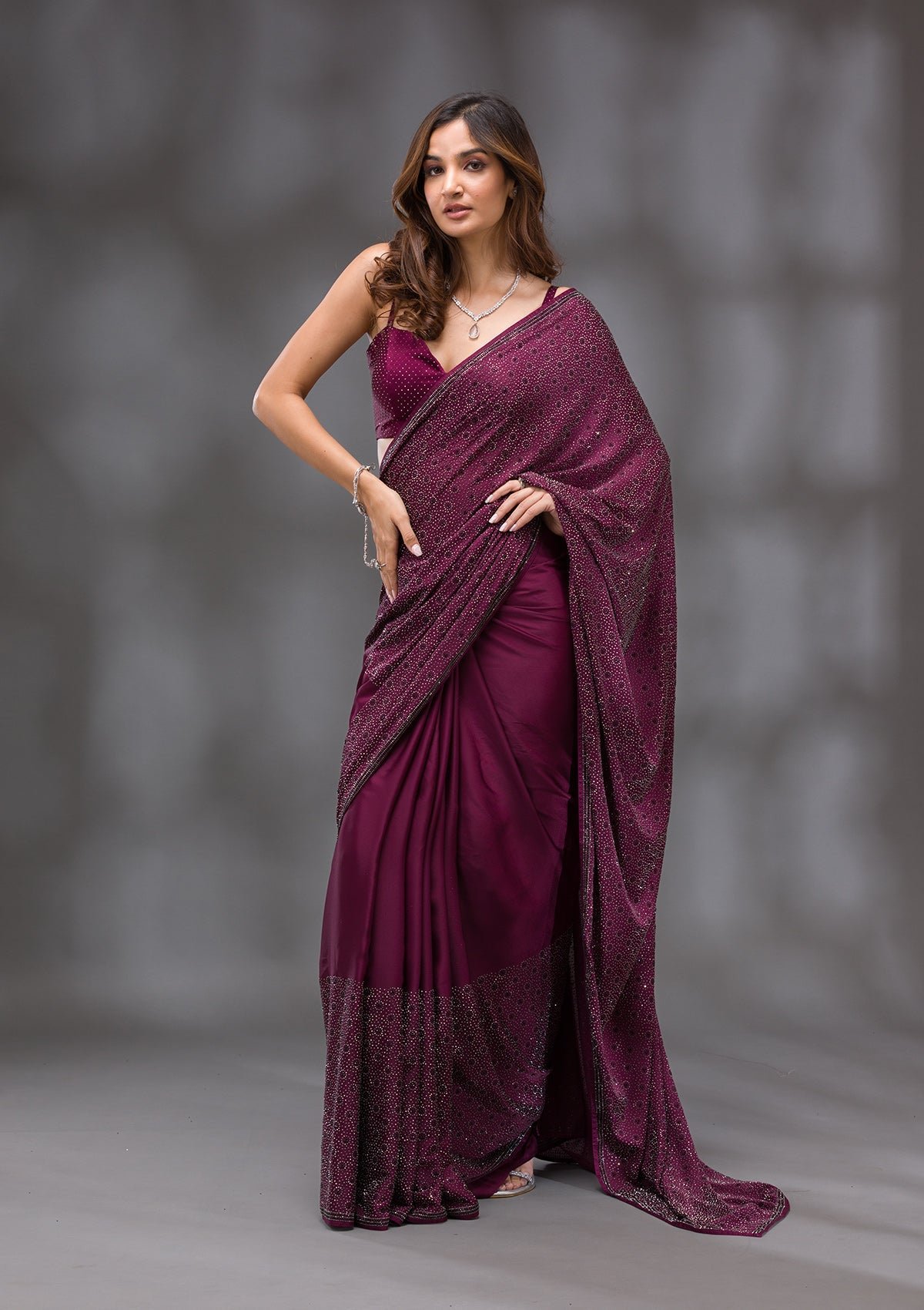 Elegantly Crafted Wine Swarovski Crepe Designer Saree